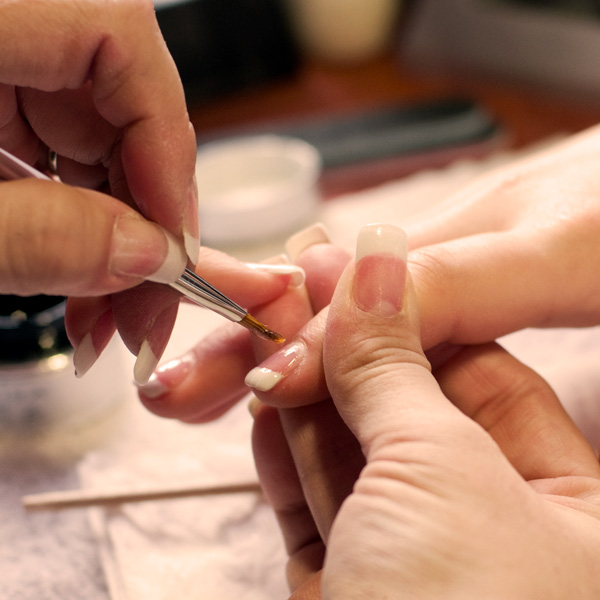 woman receiving manicure